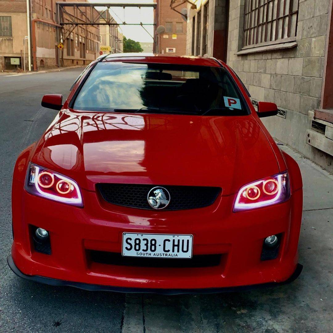 Holden VE Series 1 Black DRL Headlights Red Car