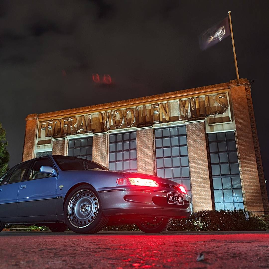 Holden VS Commodore with red angel eye headlights installed by Spectrum